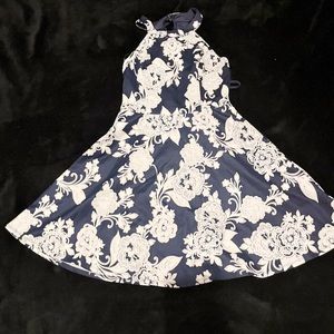 Navy blue min dress with white flowers. Halter neck. Tie up and zipper back